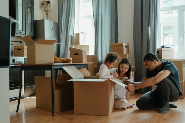 Family packing to move after selling home quickly for cash