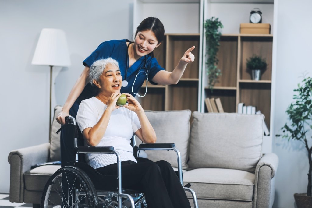 Therapist helping elderly patient in nursing home